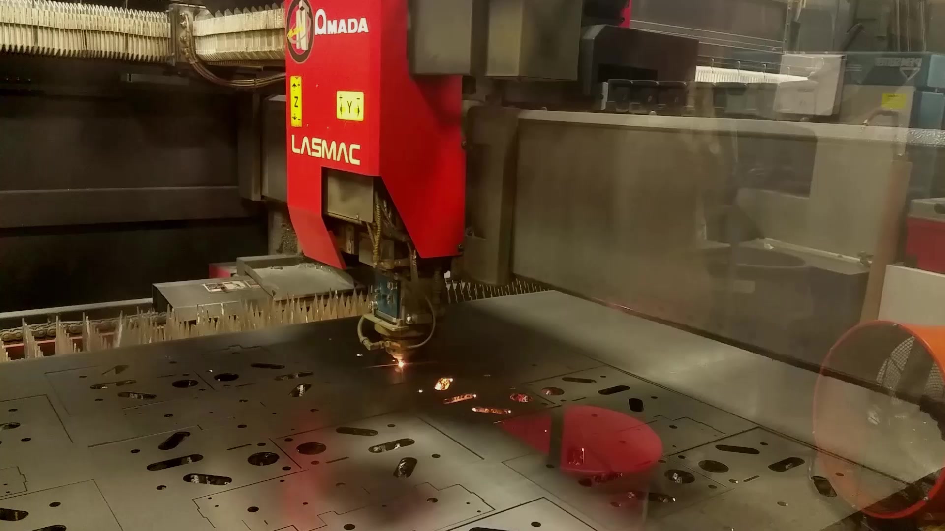 A CNC laser cutting a steel sheet