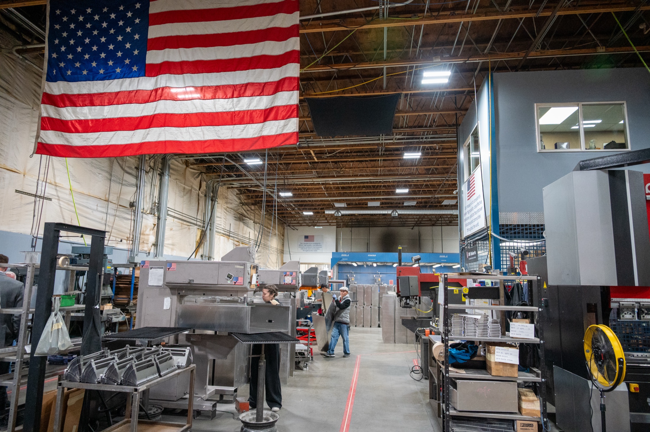 Premier's shop floor in Liberty Lake, with the US flag hanging over the machines