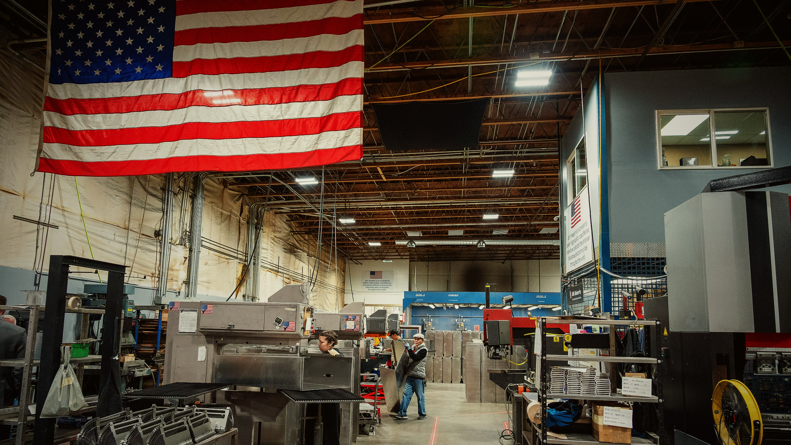 Premier's shop floor in Liberty Lake, with the US flag hanging over the machines