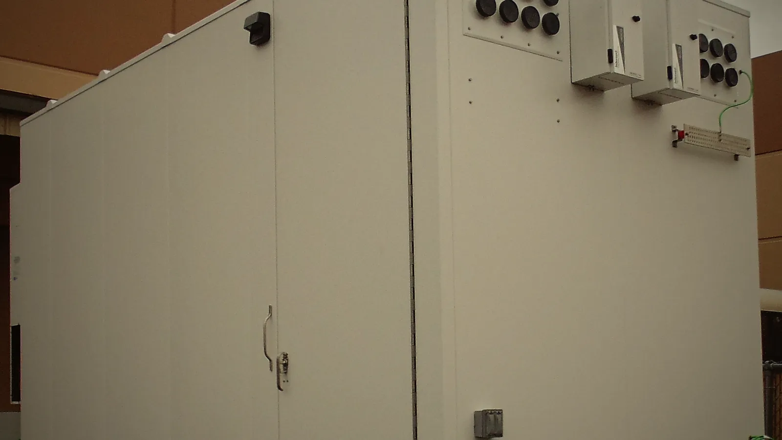 The shelter's side wall with its door and cable entry ports