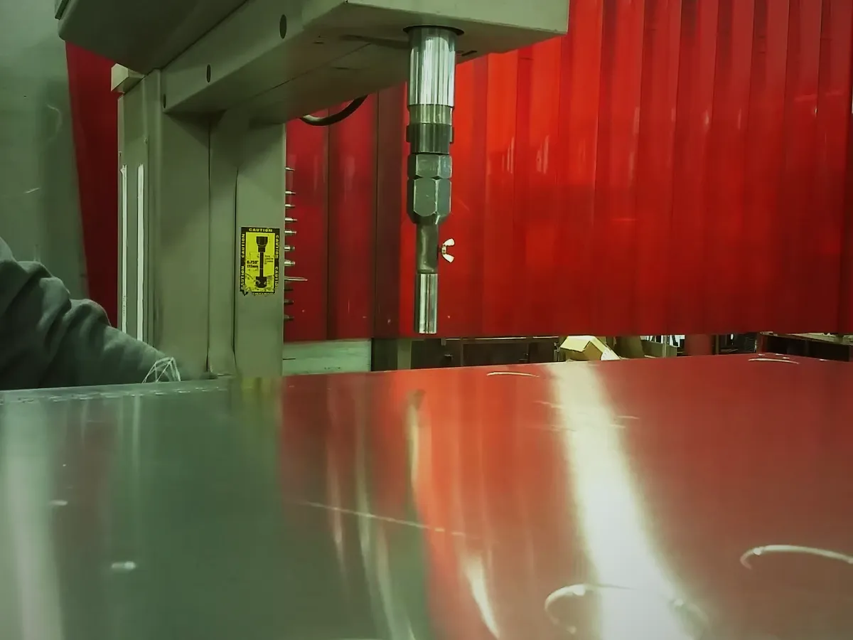 Hardware being pressed into a sheet metal part