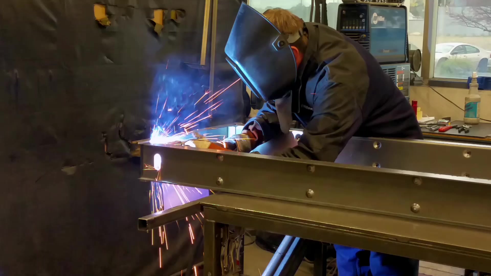 A welder at work on a steel frame